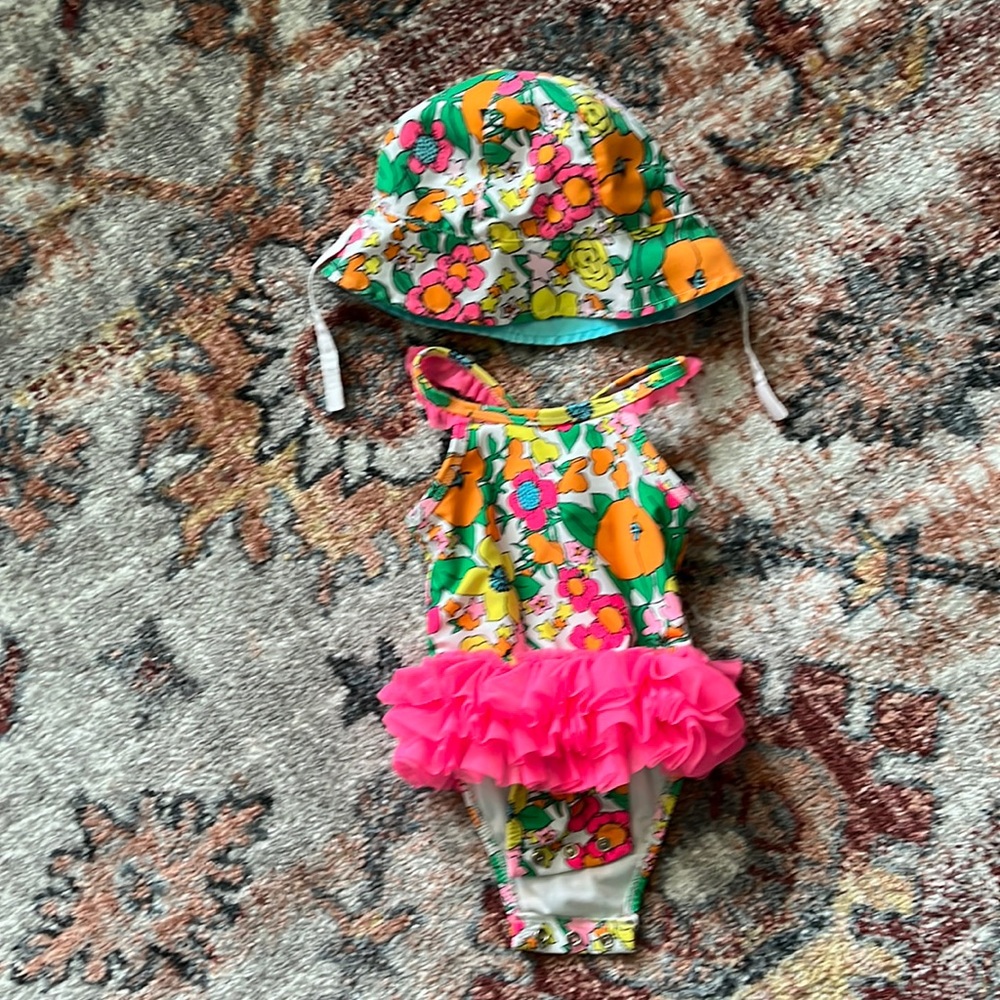 Like new bathing suit with matching sun hat for baby girl.